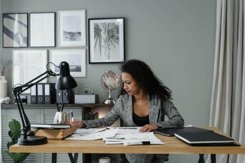 What is Net Profit? Essential Guide to Understanding and Calculation 8 Businesswoman evaluates documents at a modern desk in a stylish office setting.